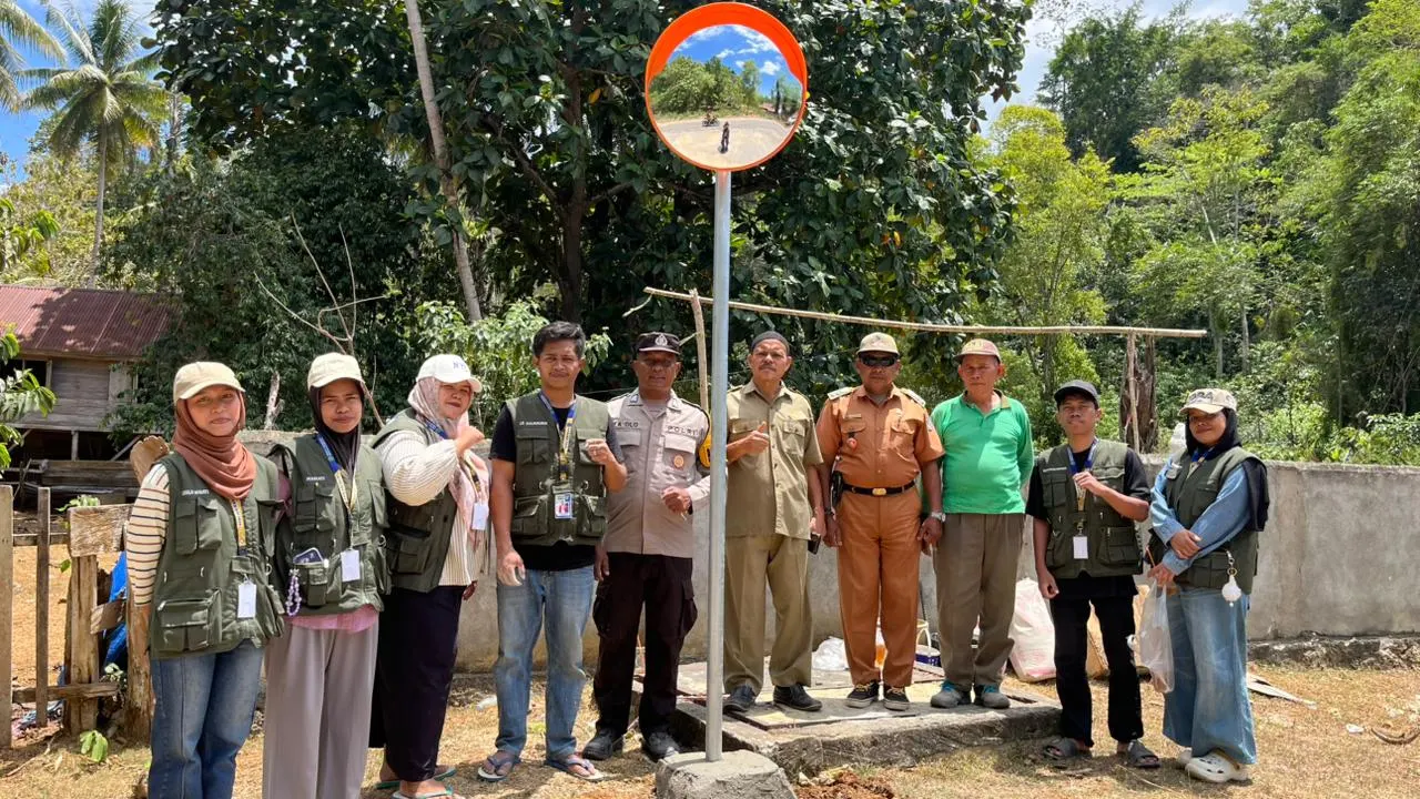 Mahasiswa KKN ADI Kelurahan Wamelai bersama Kapolsek Kecamatan Lawa saat pemasangan cermin jalan di Jalan Wantoramata.